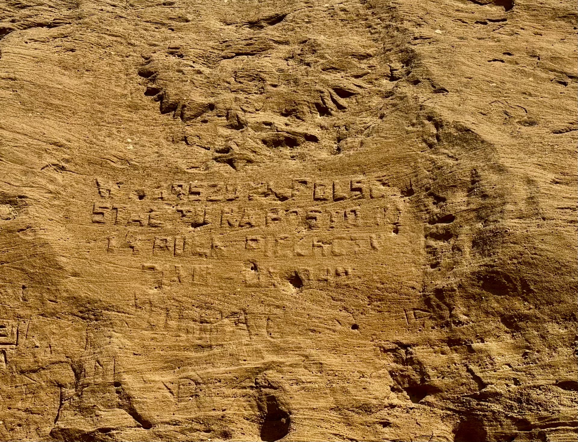 Detail of the Polish inscriptions cut into the rock face near the camp site, weathered but still legible after more than eighty years.