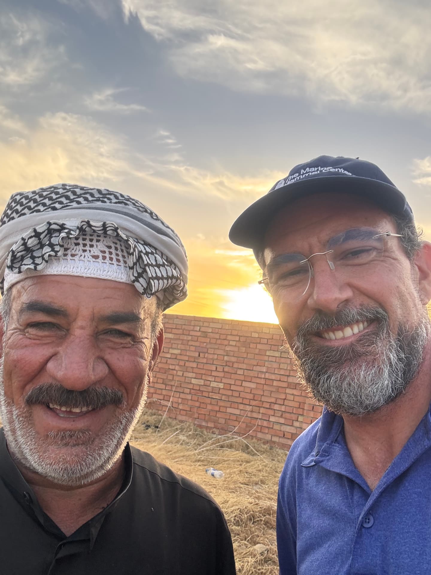 The author with a local guide at Ma'asker al Raschid at sunset, at the close of the photographic survey.