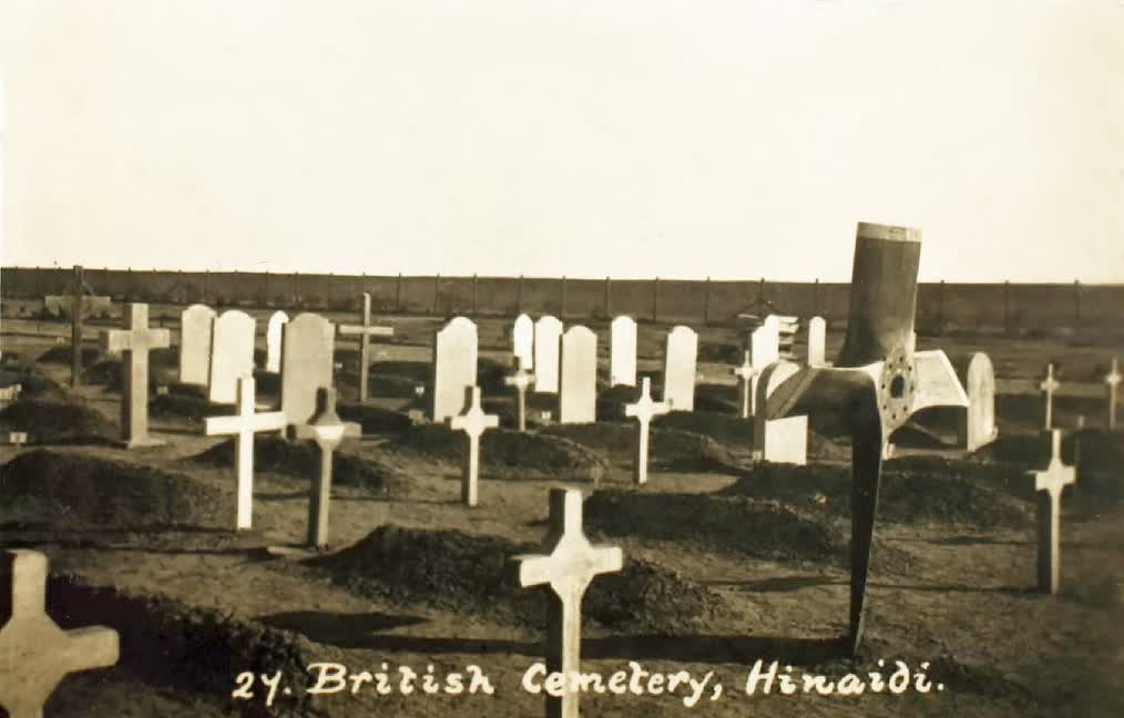 "British Cemetery, Hinaidi", a postcard view of the burial ground in 1923, the earliest graves marked with wooden crosses and temporary headstones, with an aircraft propeller set up as a marker over an airman's grave.