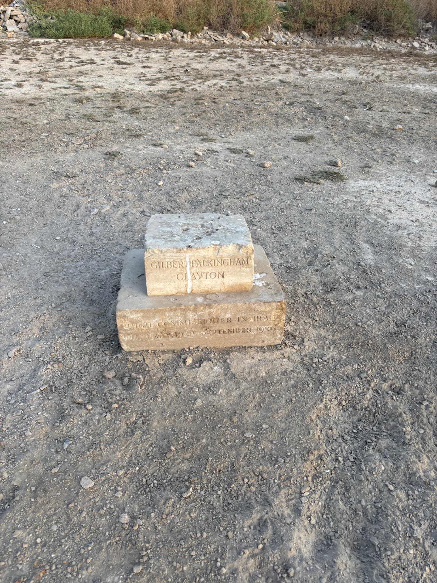 The remains of the grave of Sir Gilbert Falkingham Clayton, High Commissioner in Iraq, 1 May 1929 to 3 September 1929, who unveiled the Basra Memorial in March 1929 and died in office in Baghdad. All that survives is the inscribed stone resting on its plinth in the open ground.
