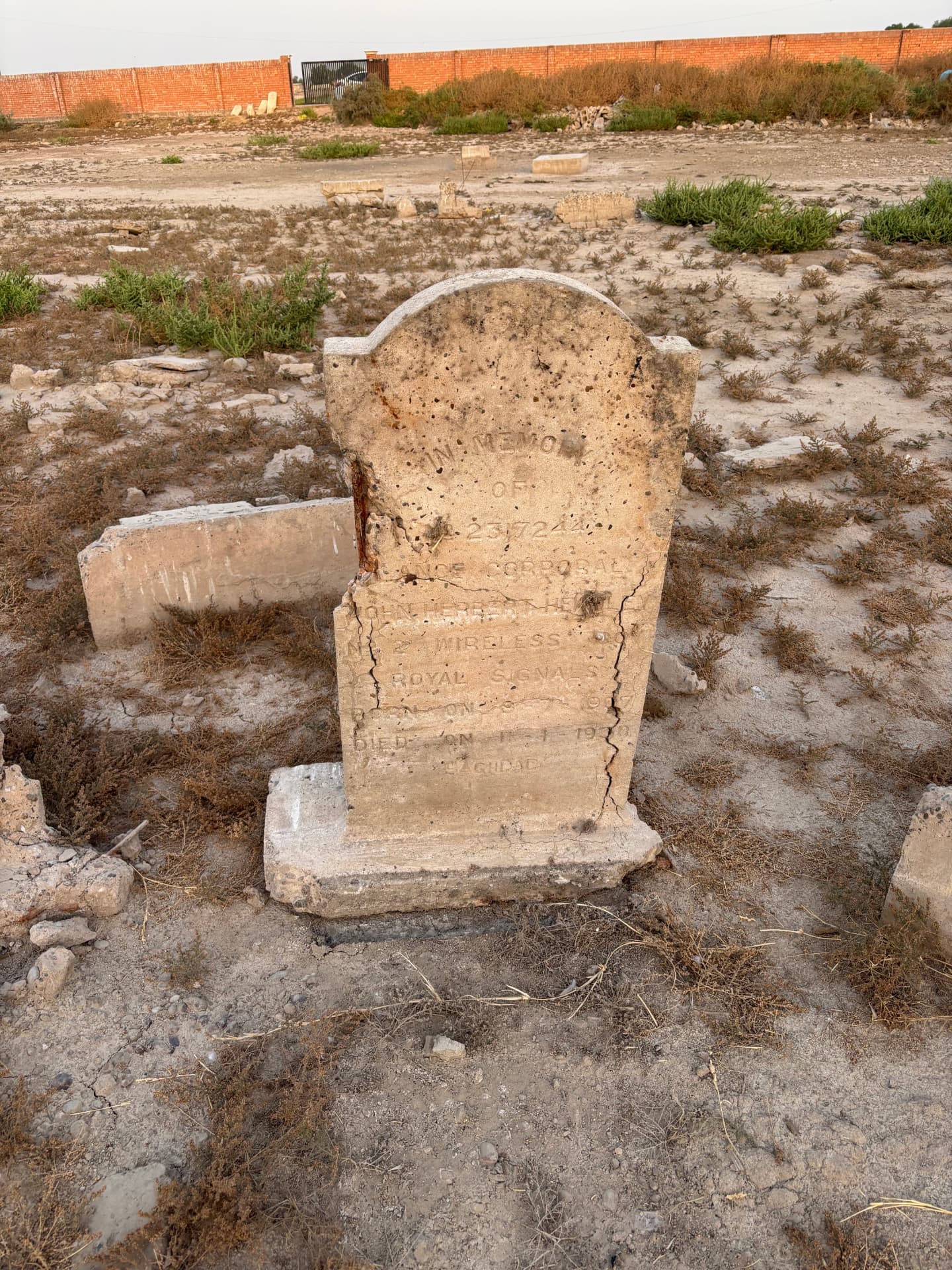 2317244 Lance Corporal John Herbert Heath, No. 2 Wireless, Royal Signals, died 1930, Baghdad. The headstone stands cracked and eroded amid scattered fragments of other graves.