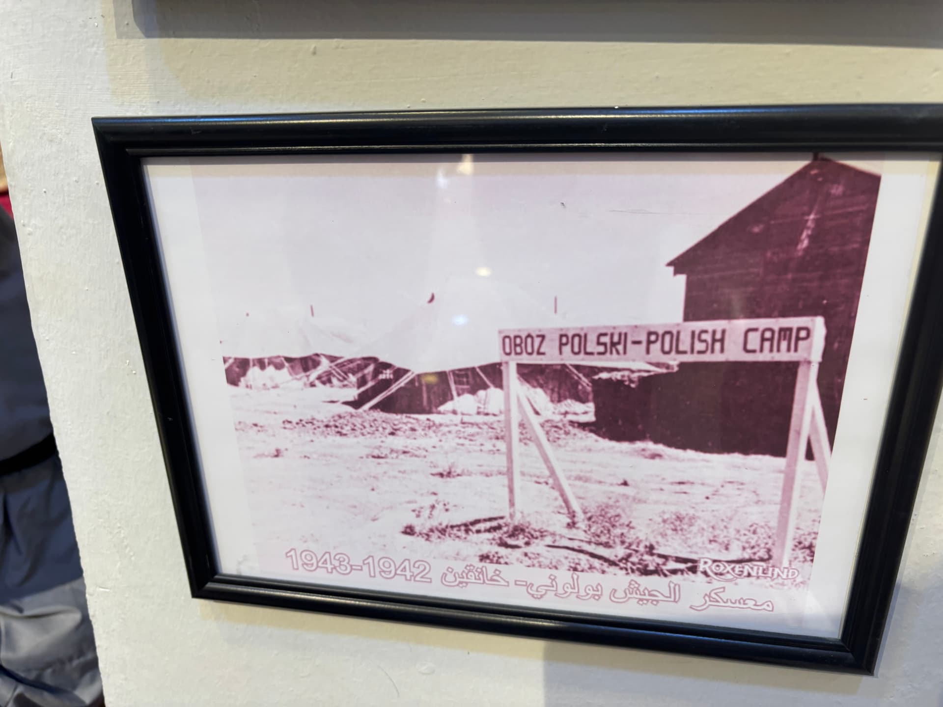A framed photograph in the museum showing the entrance to the Polish camp at Khanaqin, marked Oboz Polski, Polish Camp, 1942 to 1943.