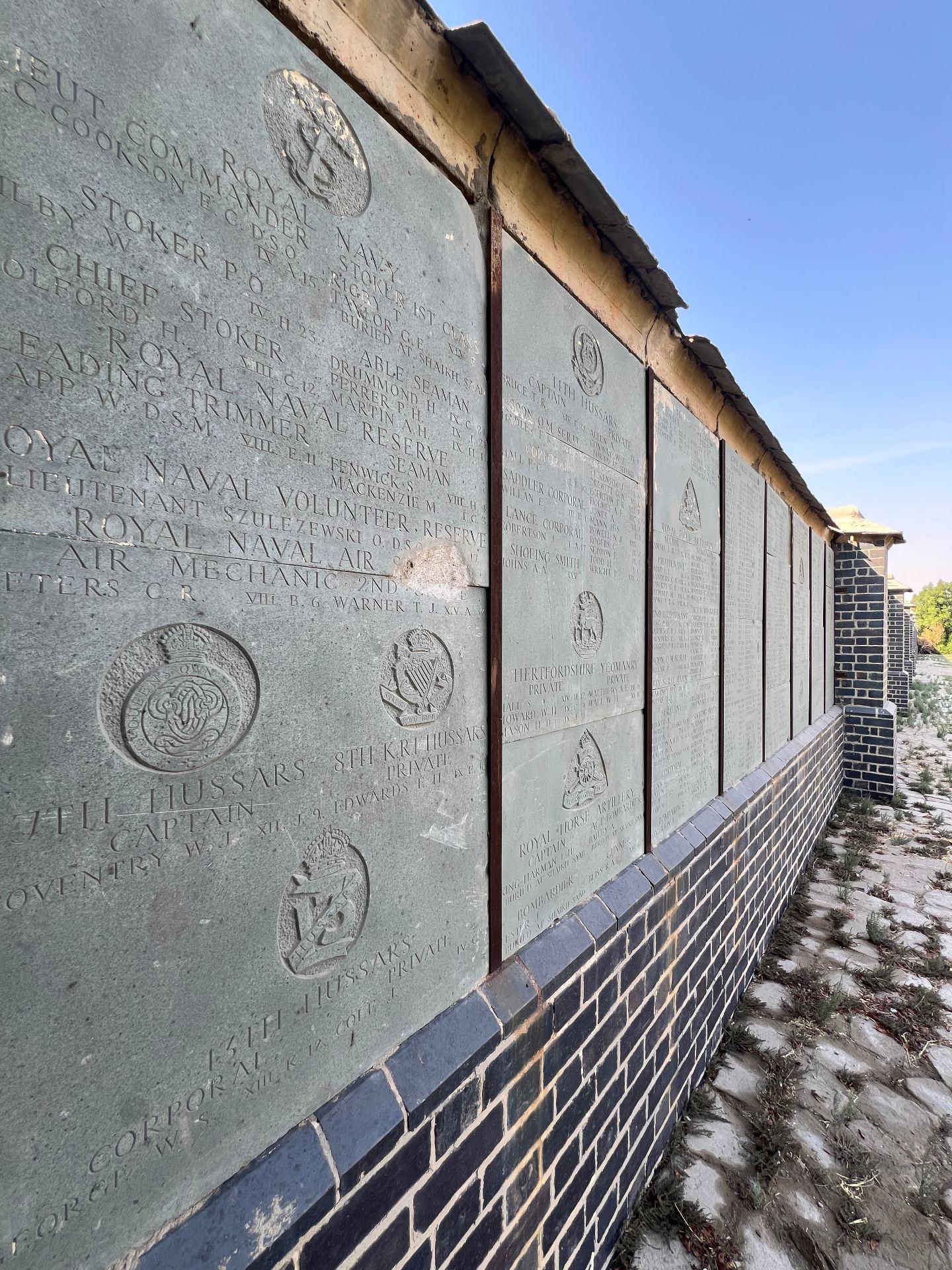 The renovated Memorial Wall today, with panels intact and well displayed following Mr Hasan's 2022 renovation. The opening panel records Lt Commander Cookson VC of the Royal Navy.