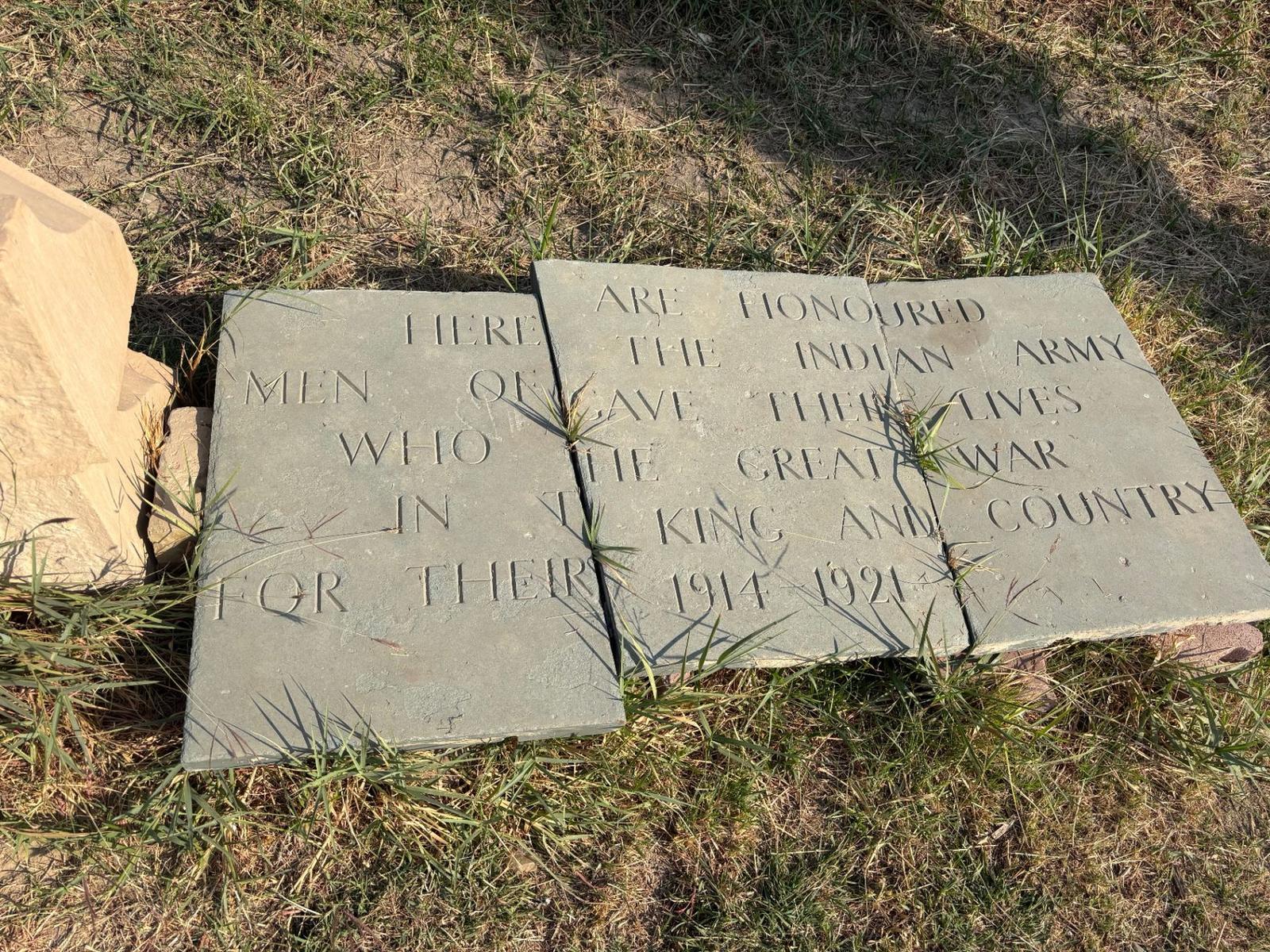 Rescued inscription panels from the Amara Indian Forces Memorial laid out on the grass