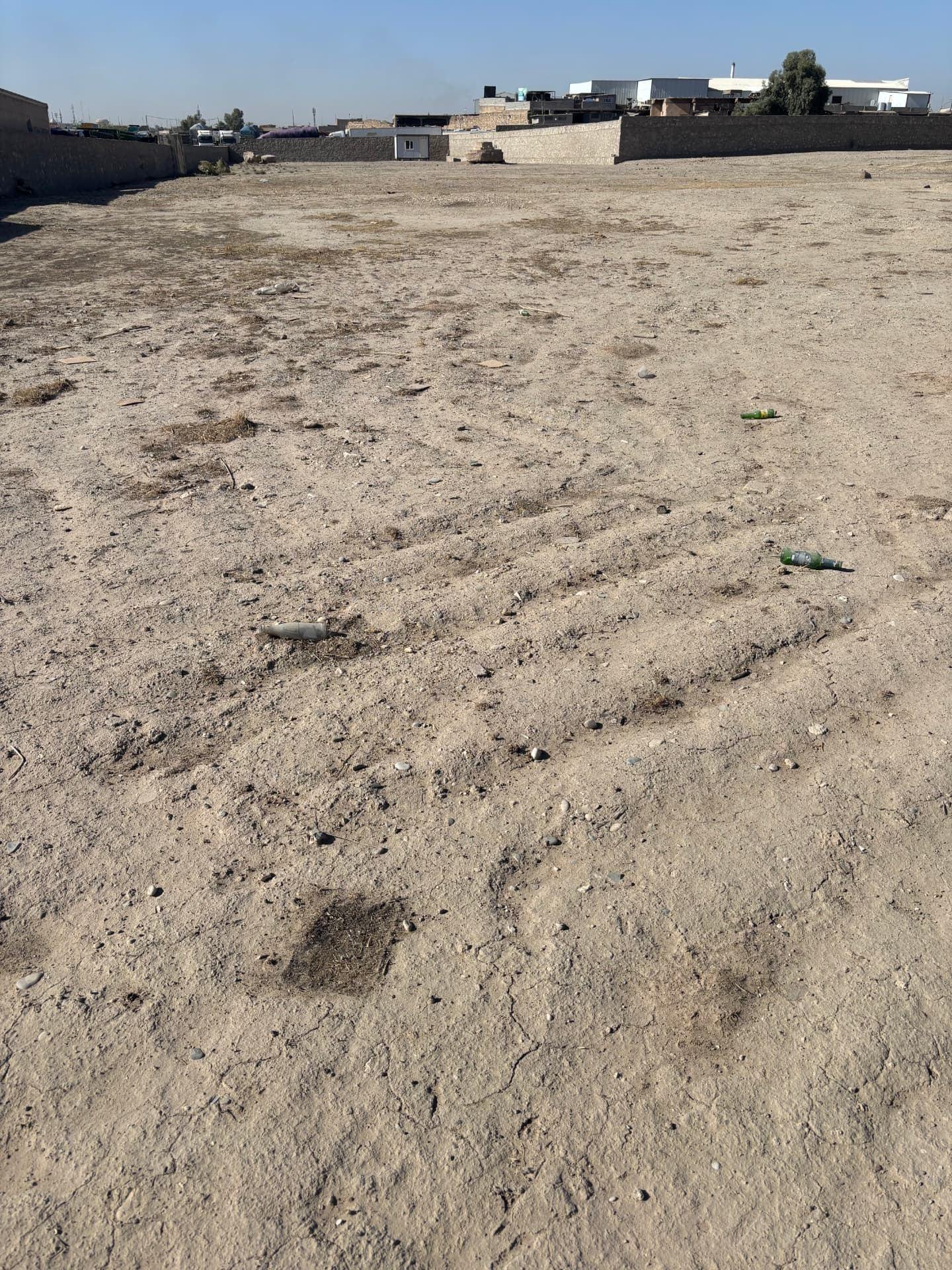 The cemetery today, levelled to bare earth with bulldozer tracks still visible across the ground. Every headstone and sub base has gone, along with the graves' surface markings.