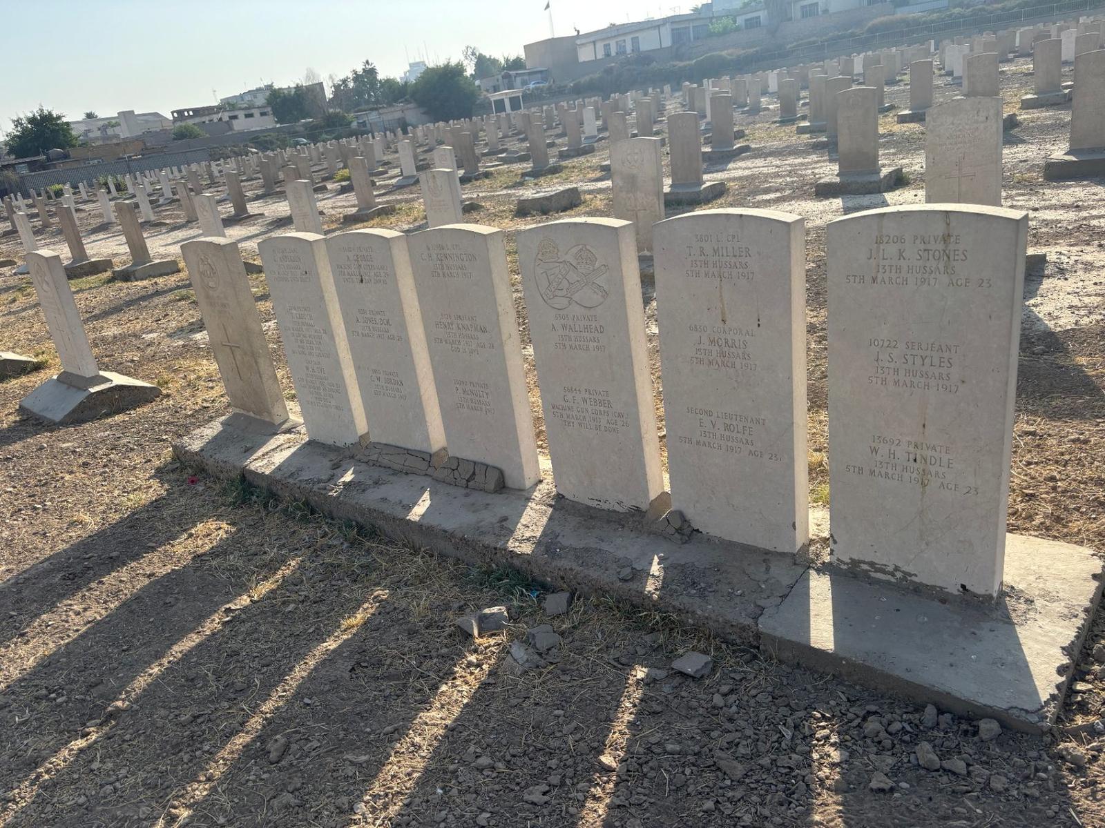 A cluster of graves at Baghdad Northgate from the Battle of Lajj, 5 March 1917, including headstones of the 13th Hussars and Machine Gun Corps (Cavalry). Several stones are inscribed with shared burials, indicating commingled remains from the action.