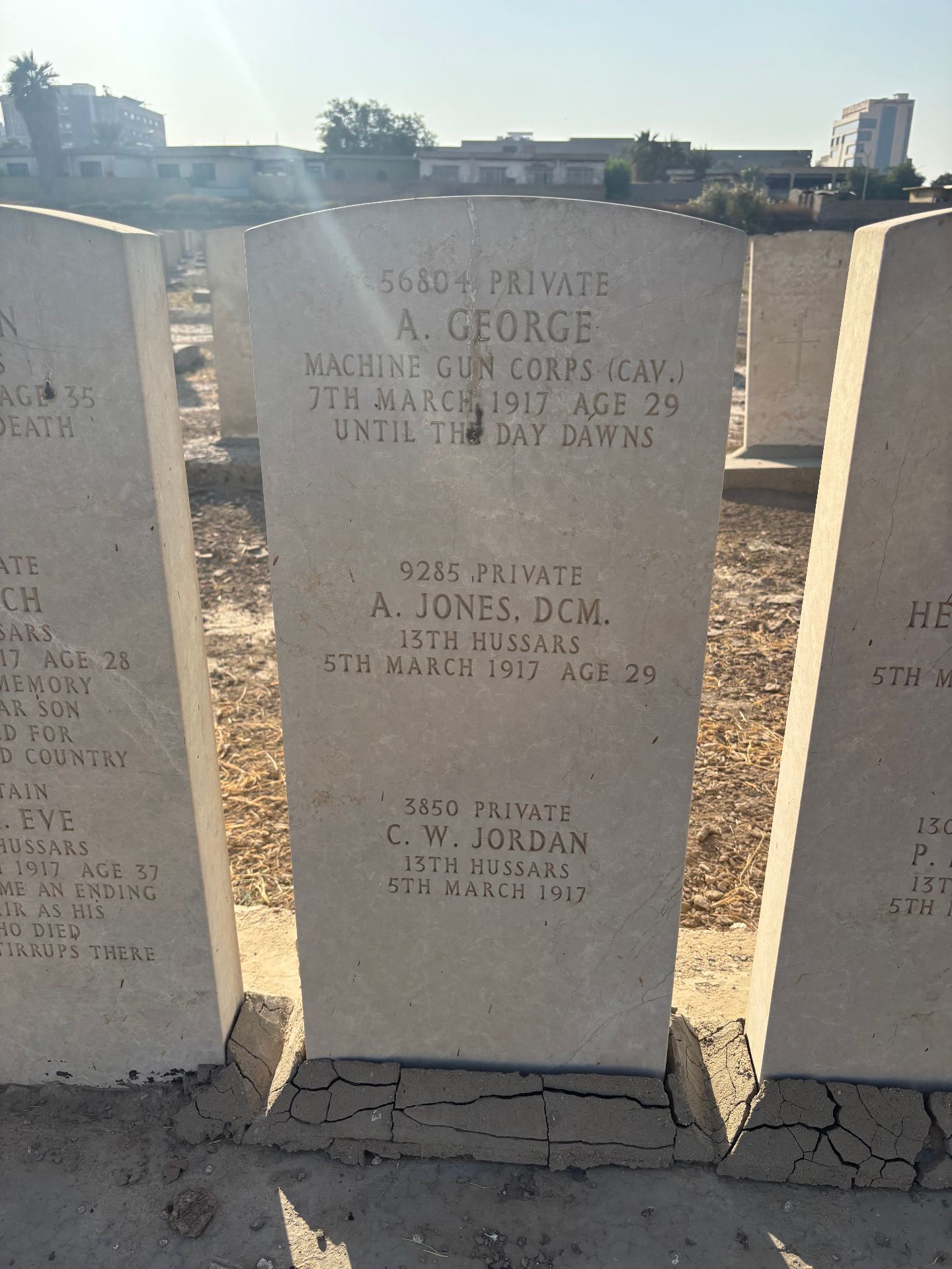 A shared headstone commemorating 56804 Private A. George, Machine Gun Corps (Cavalry), killed 7 March 1917, age 29 ("Until the day dawns"); 9285 Private A. Jones, DCM, 13th Hussars, killed 5 March 1917, age 29; and 3850 Private C. W. Jordan, 13th Hussars, killed 5 March 1917.