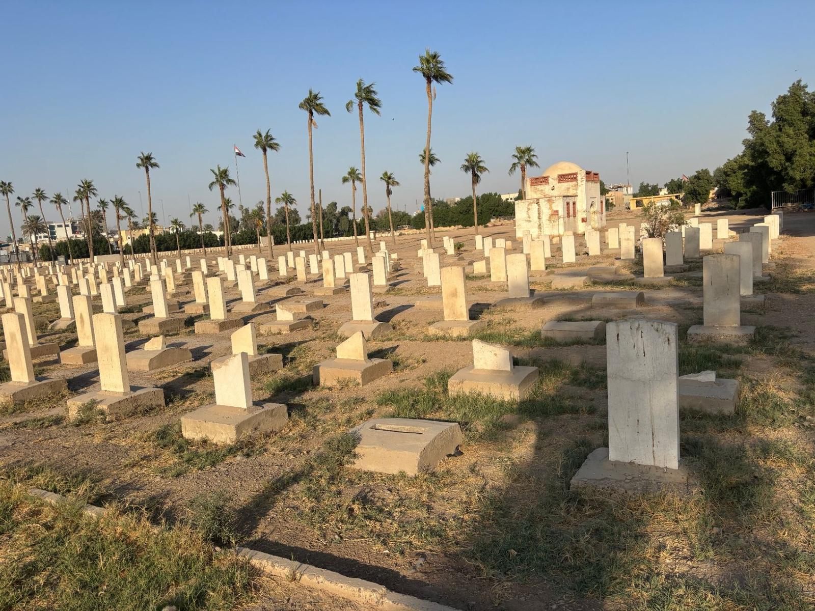 Headstones with the gatehouse in the background.